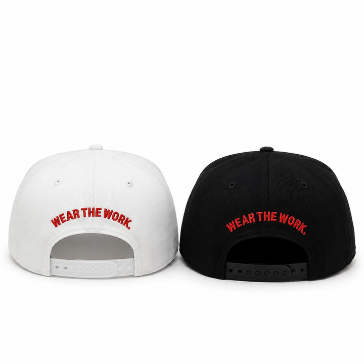 Translation missing: en.Two snapback caps shown from the back on a white background, one white and one black, both with red embroidered text reading 'WEAR THE WORK.'