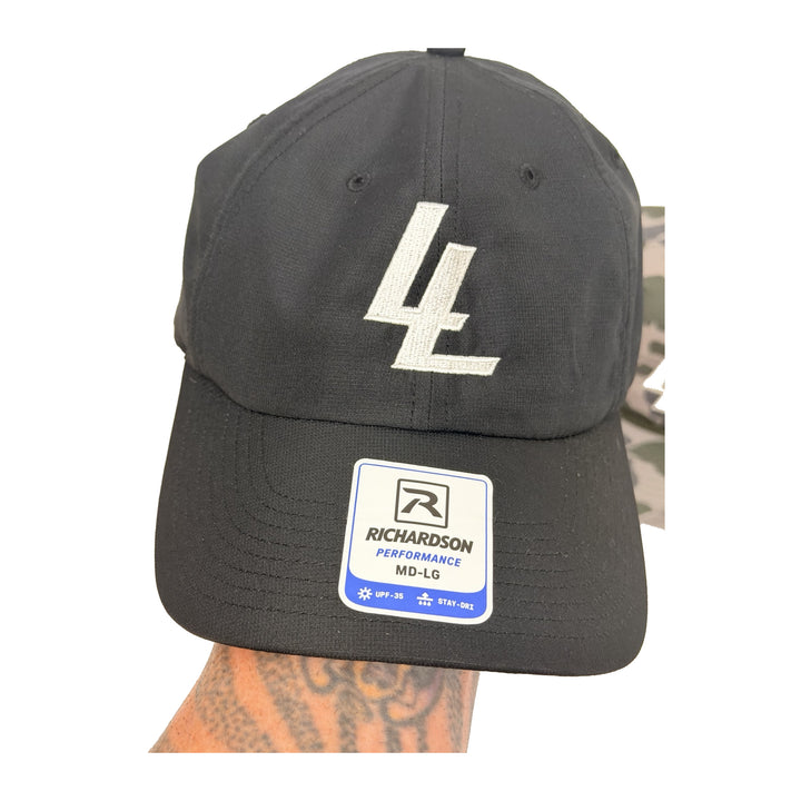 Translation missing: en.A black baseball cap with a white embroidered 'LL' logo on the front and a white Richardson Performance sticker on the brim, shown against a white background