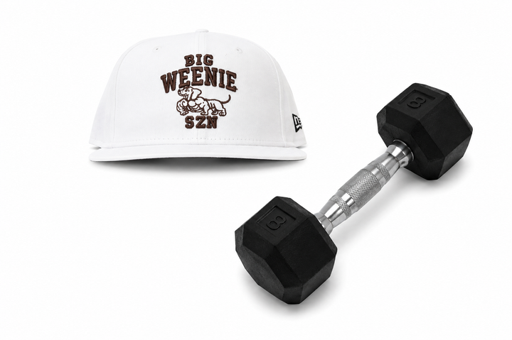 Translation missing: en.A white baseball cap with brown 'BIG WEENIE SZN' text and a graphic on the front, shown next to a black hex dumbbell on a white background