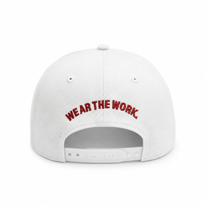 Translation missing: en.White baseball cap shown from the back, featuring the phrase 'WEAR THE WORK.' embroidered in red arched lettering across the center