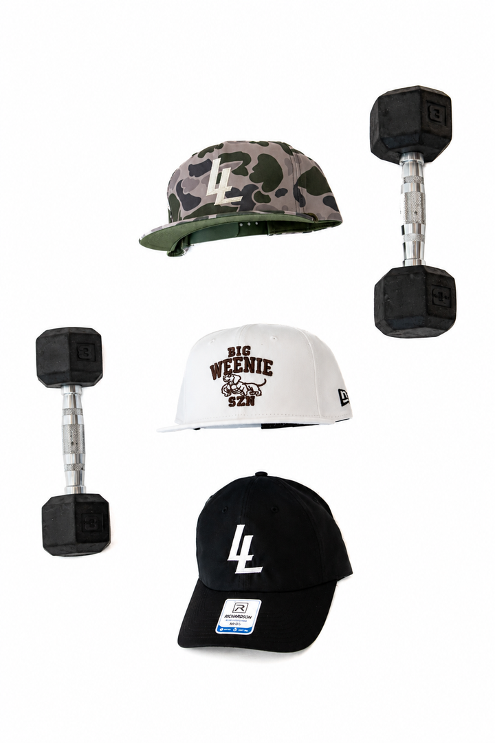 Translation missing: en.Three caps and two small dumbbells arranged on a plain white background. The caps include a camouflage cap with a cream 'LL', a white cap with 'BIG WEENIE SZN' text, a black cap with a white 'LL' logo