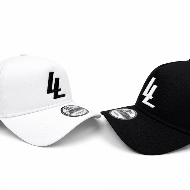 Translation missing: en.Two baseball caps shown on a clean white background: one white cap with a black embroidered 'LL' logo and one black cap with a white embroidered '4L' logo. Both caps show a circular New Era sticker on the brim