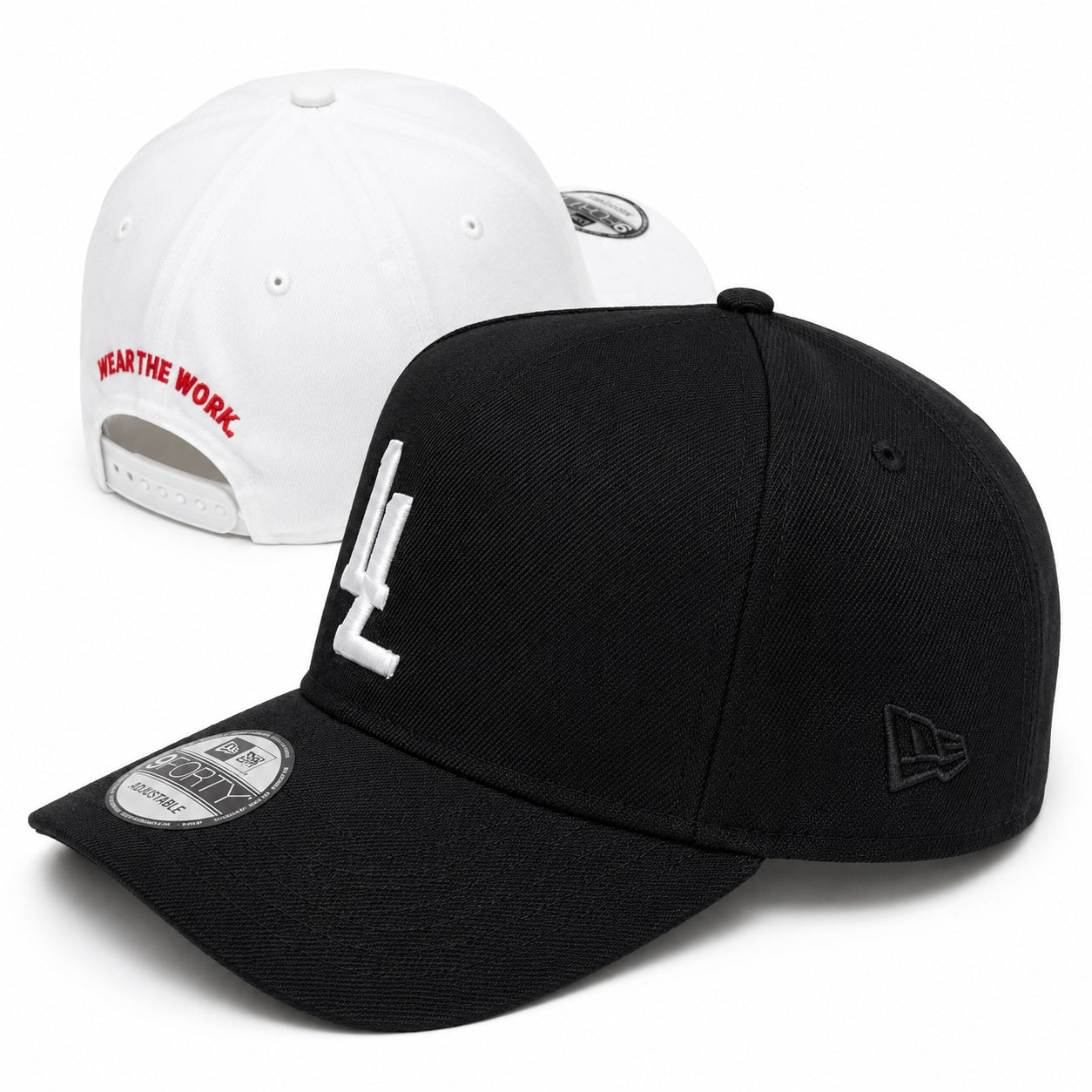 Translation missing: en.Two baseball caps shown on a white studio background: a black cap in front with a white embroidered LL logo on the front and a black New Era logo on the side, plus a black brim sticker; and a white cap behind it with red text reading 'WEAR THE WORK.' on the back