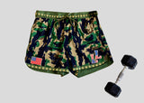 Camouflage shorts with American flag patch, American Flag LL logo and dumbbell on a light gray background