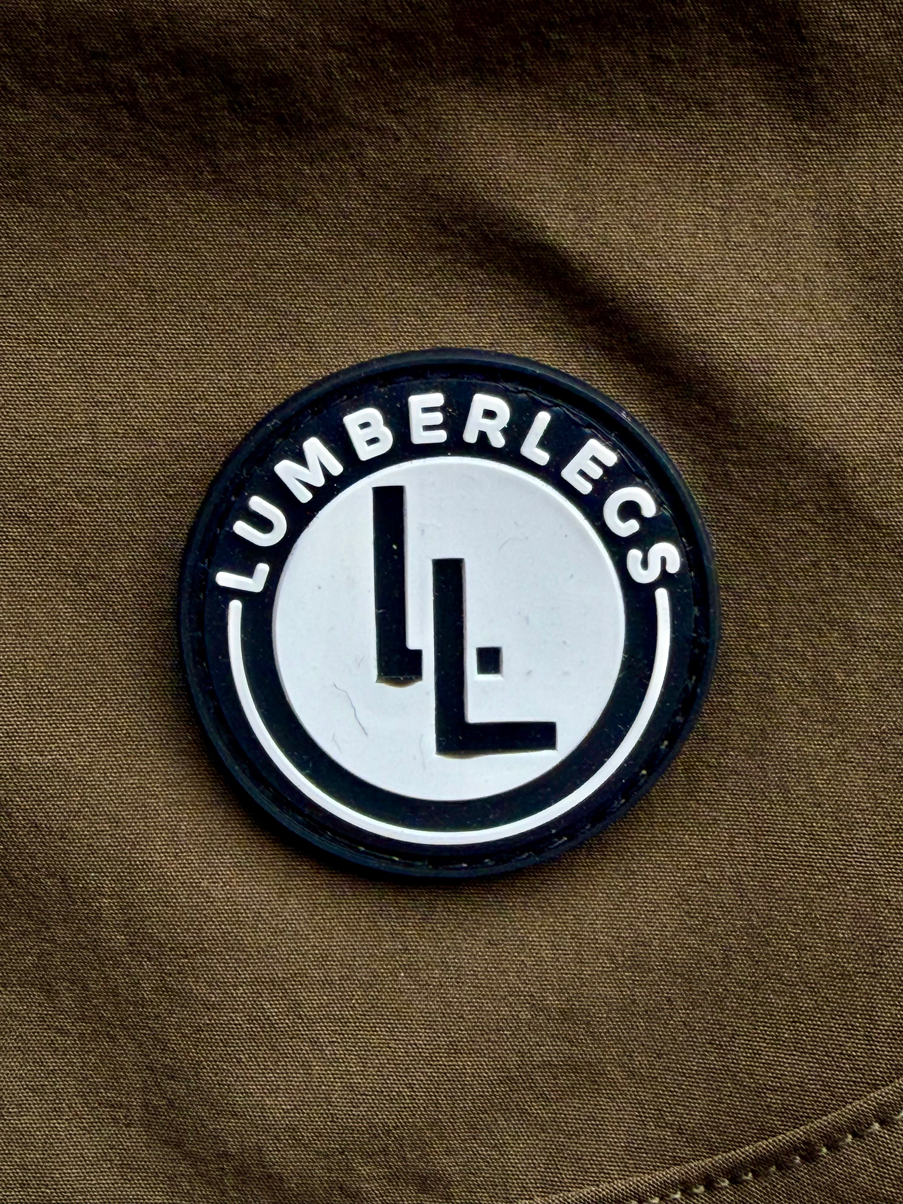Military Green gym shorts rubber logo close up.