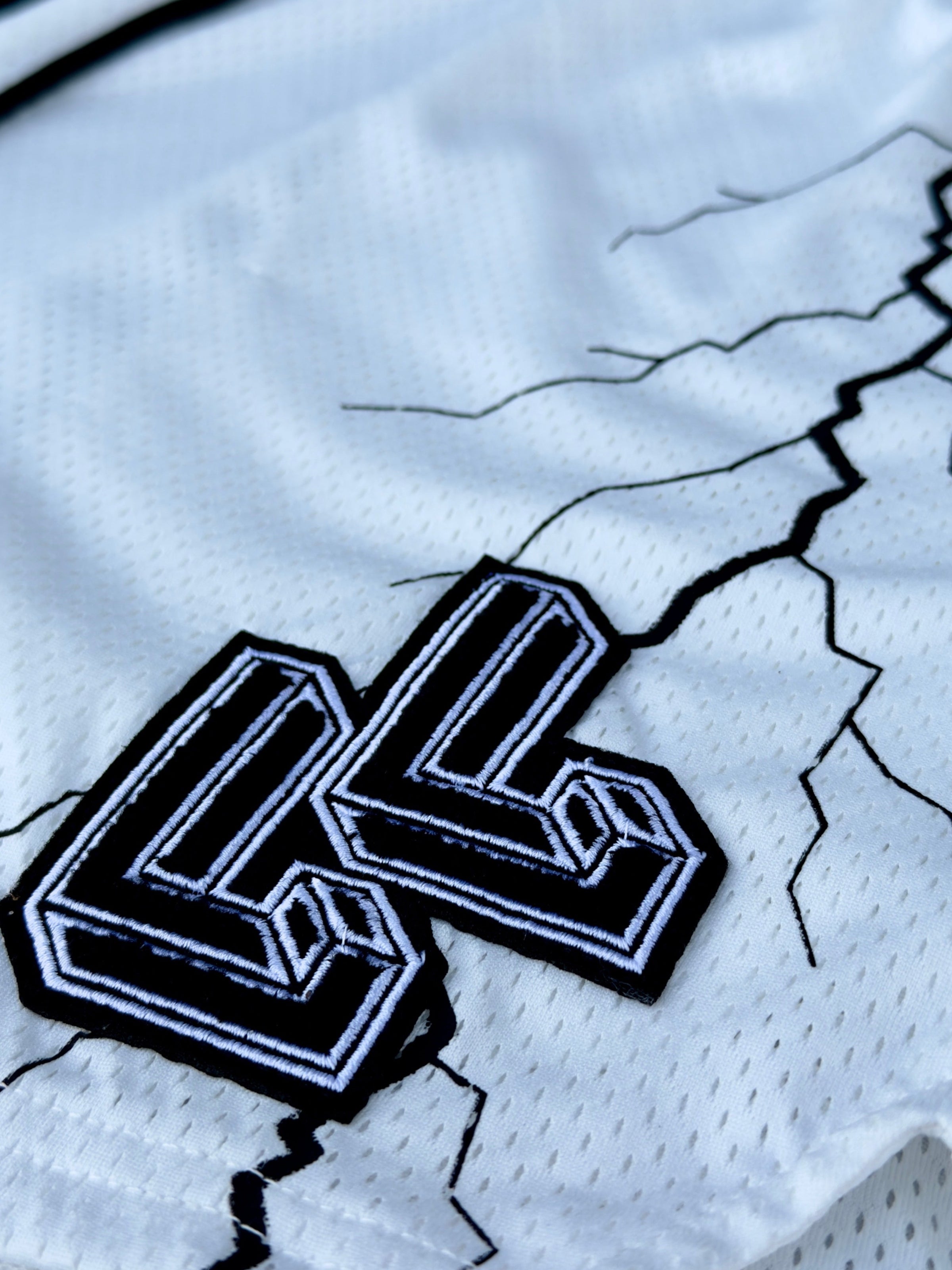 white mesh shorts with black lightning strike LL logo close-up