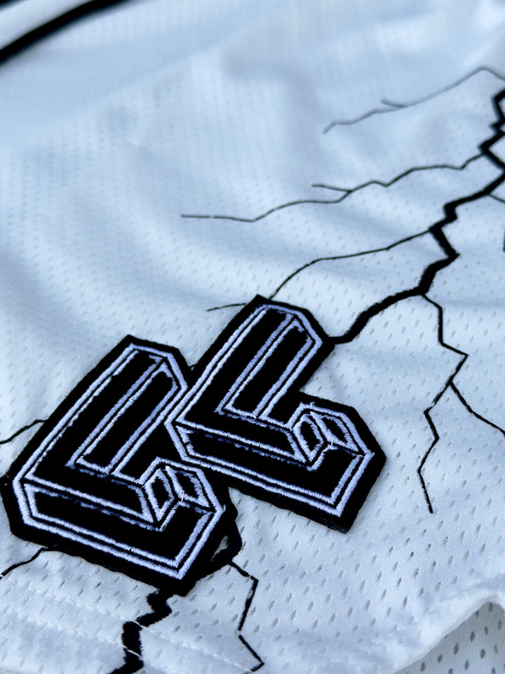 Translation missing: en.white mesh shorts with black lightning strike LL logo close-up
