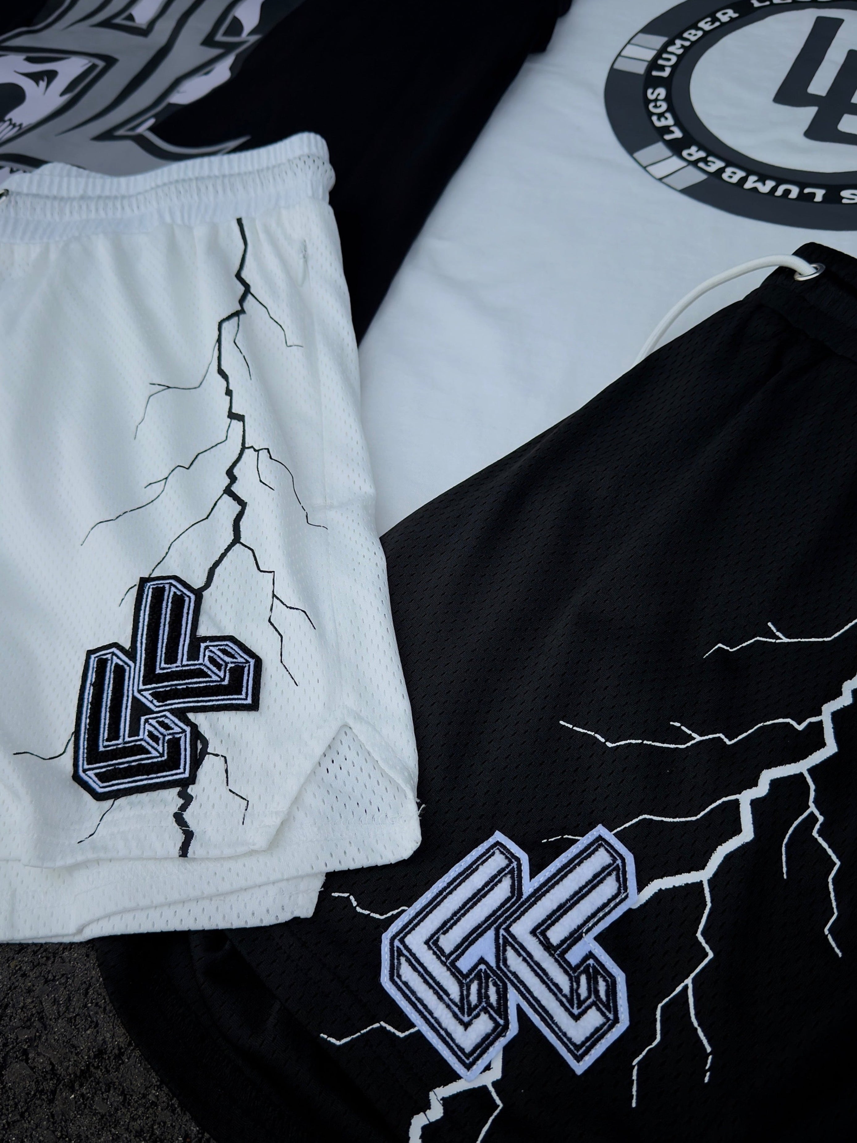 Black and white shorts with logos and designs on a textured surface