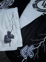 Black and white shorts with logos and designs on a textured surface