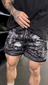 Man wearing gothic skull and cross LL gym shorts
