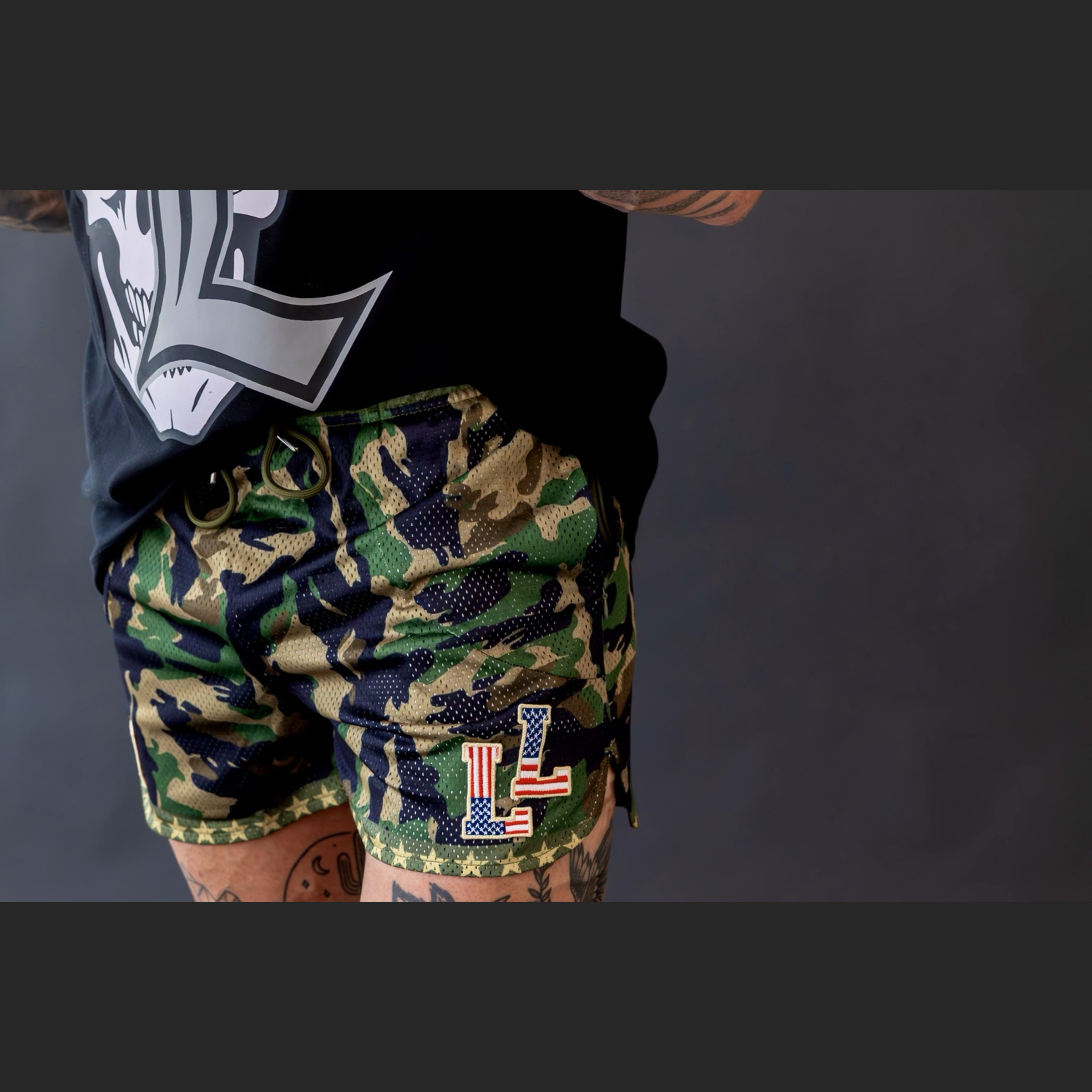 Camo mesh shorts on male model with LL American Flag logo