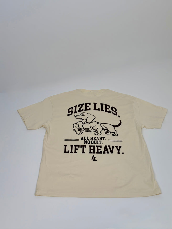 Translation missing: en.A cream-colored short-sleeve t-shirt shown from the back, featuring a brown graphic of a muscular dachshund with the text 'SIZE LIES. ALL HEART