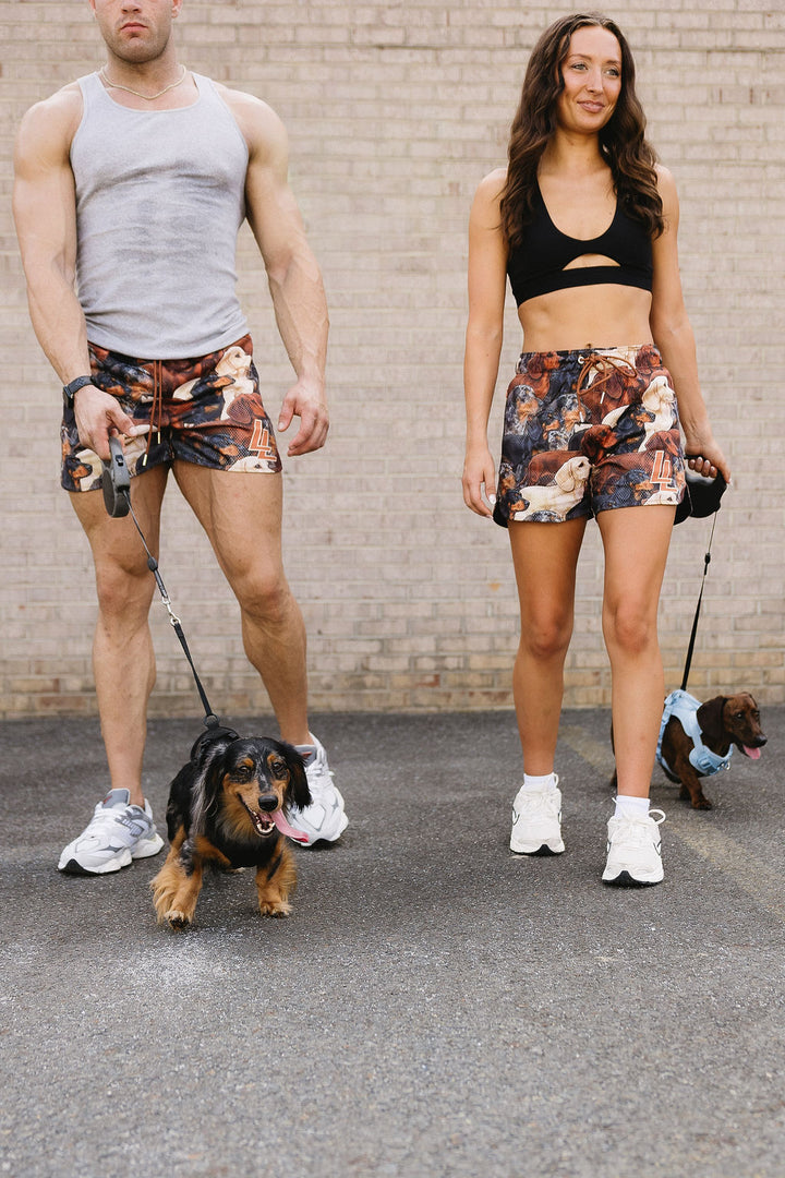 Translation missing: en.Male and female model wearing LL dachshund shorts while walking weenie dogs