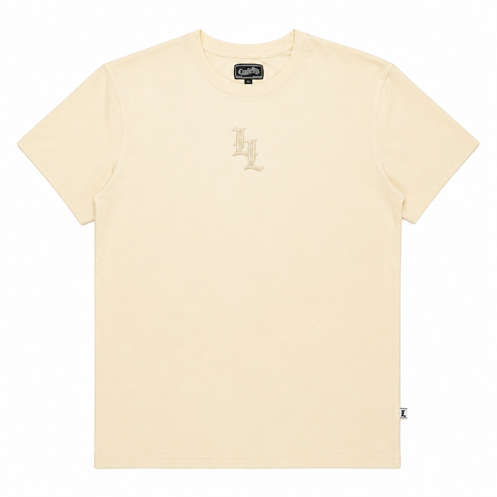 Translation missing: en.A cream-colored short-sleeve crewneck t-shirt by Cartby, featuring a small tonal embroidered 'LL' logo on the center chest and a small brand L tag near the bottom right hem