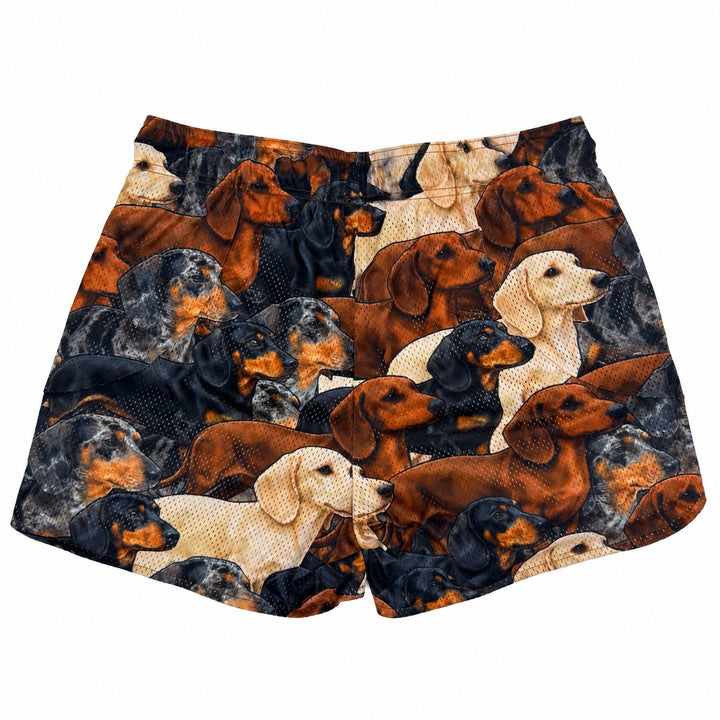 Translation missing: en.A pair of athletic mesh shorts featuring an all-over print of various dachshund dogs in black, tan, cream, and gray, set against a plain white background